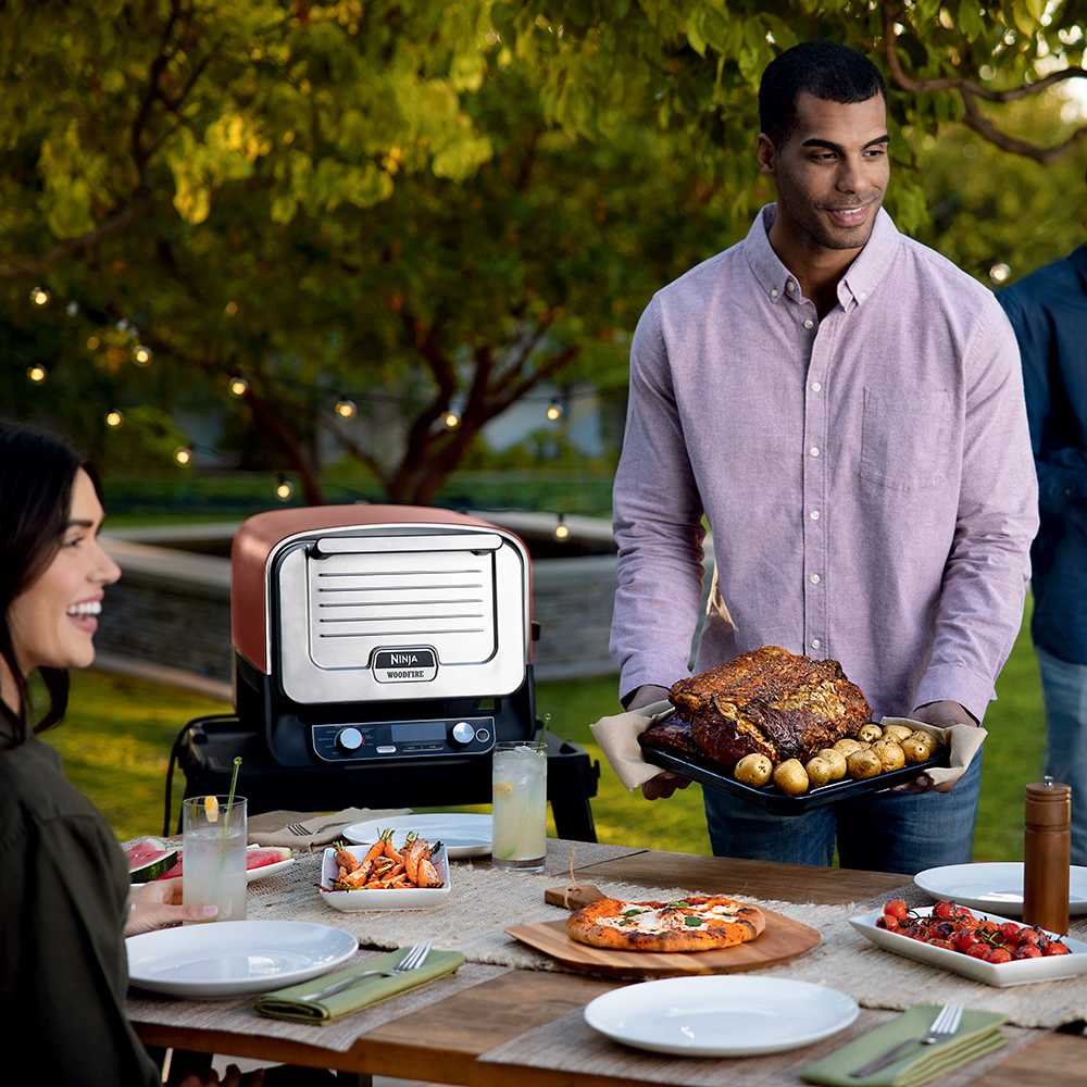 Ninja OO101 outdoor oven in use on an outdoor table
