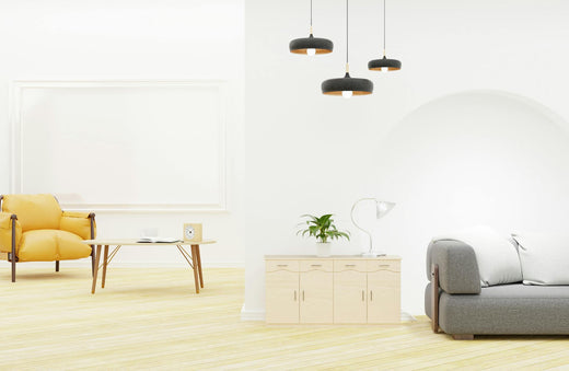 Bright and minimal second living room design featuring a yellow armchair, a wooden coffee table, a gray sofa, and a cabinet with a potted plant, under modern hanging pendant lights.