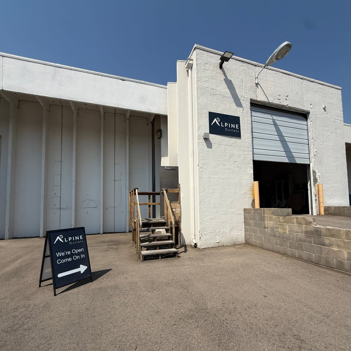 Exterior entrance of Alpine Outlets Fort Collins on Canal Drive.
